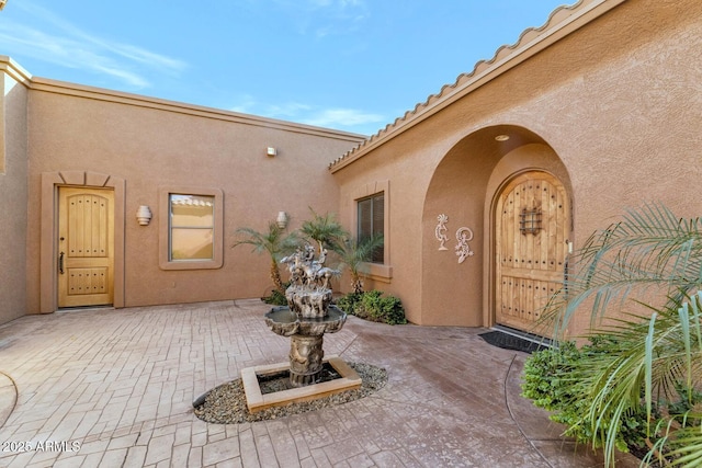 property entrance featuring a patio area