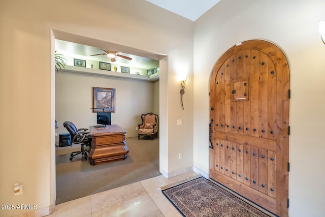 entryway featuring ceiling fan and light tile patterned flooring