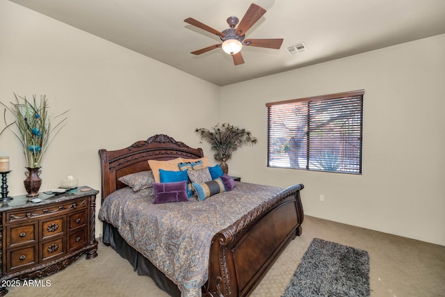 bedroom featuring ceiling fan and light carpet