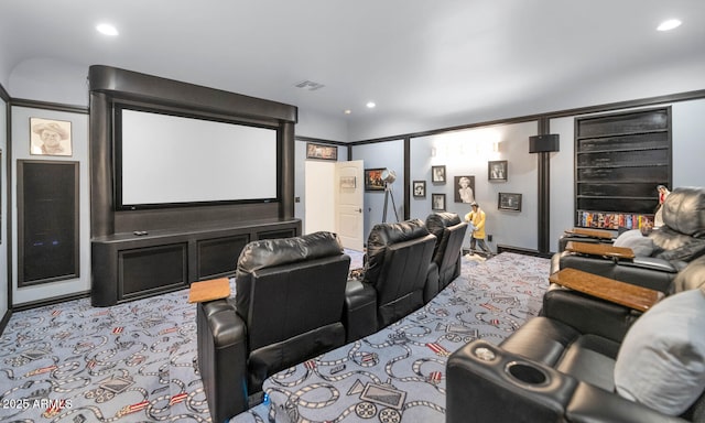 cinema room featuring light carpet