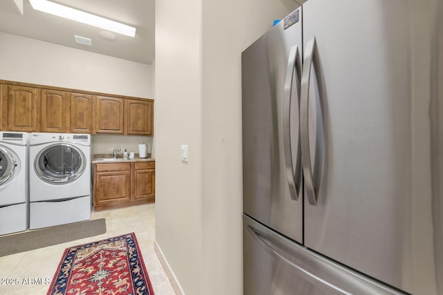 clothes washing area with sink and washer and clothes dryer