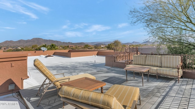 wooden terrace with outdoor lounge area and a mountain view