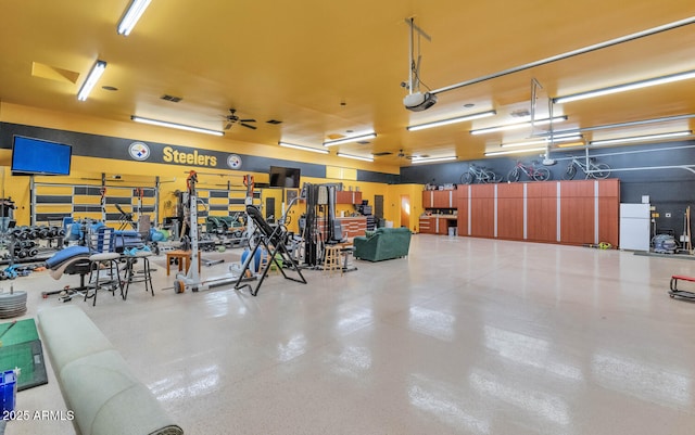 garage with ceiling fan and a garage door opener