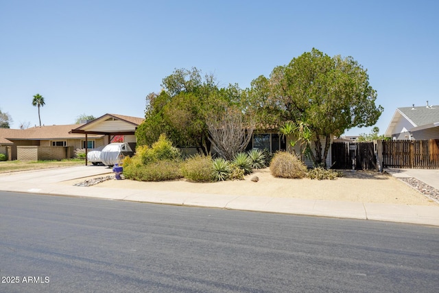 15212 N 37th Ave, Phoenix, AZ 85053 - obstructed view of property with fence, a gate, driveway, and a carport
