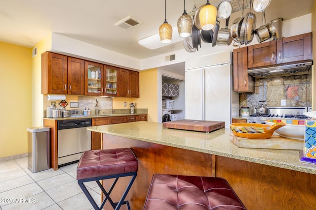 15212 N 37th Ave, Phoenix, AZ 85053 - kitchen with stainless steel dishwasher, under cabinet range hood, visible vents, and light stone countertops