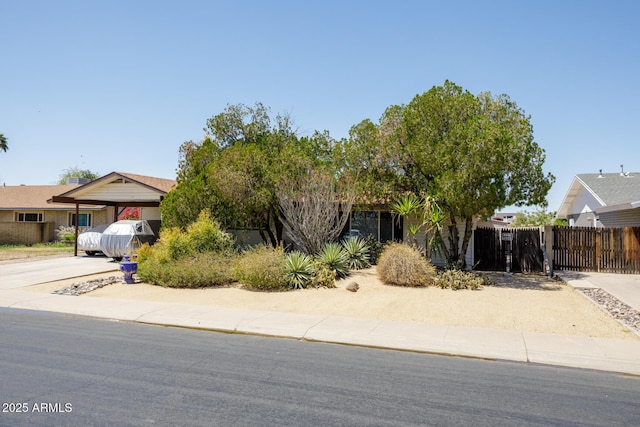 15212 N 37th Ave, Phoenix, AZ 85053 - view of property hidden behind natural elements featuring fence, a gate, and a carport