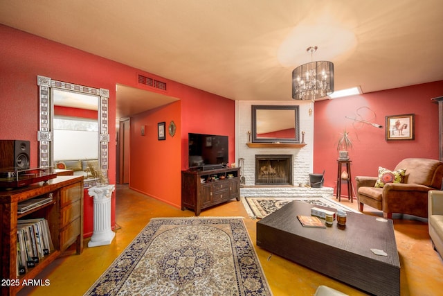 15212 N 37th Ave, Phoenix, AZ 85053 - living room with visible vents, finished concrete flooring, a brick fireplace, and an inviting chandelier