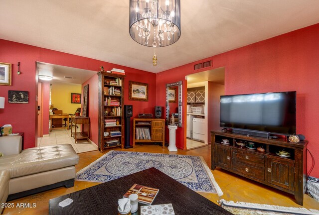 15212 N 37th Ave, Phoenix, AZ 85053 - living room with visible vents, washer / clothes dryer, and a notable chandelier