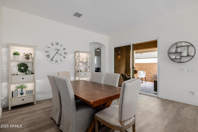 dining space with hardwood / wood-style floors