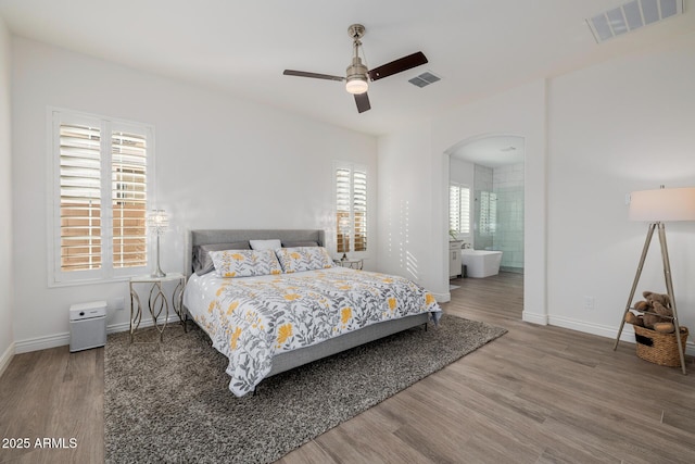 bedroom featuring hardwood / wood-style floors, ensuite bath, and ceiling fan