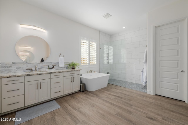 bathroom featuring vanity, independent shower and bath, and hardwood / wood-style floors