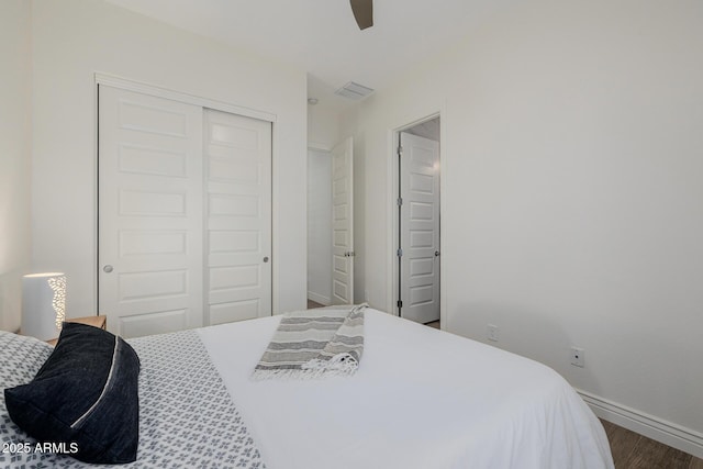 bedroom with hardwood / wood-style floors, a closet, and ceiling fan