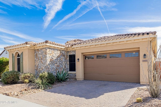 mediterranean / spanish house with a garage