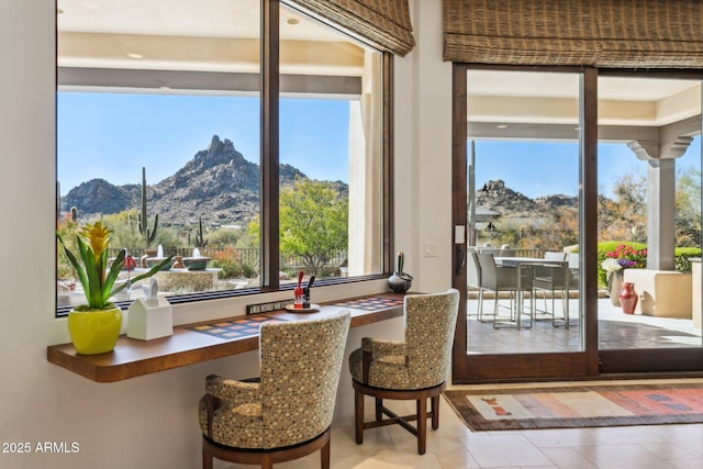 doorway with a mountain view and a healthy amount of sunlight