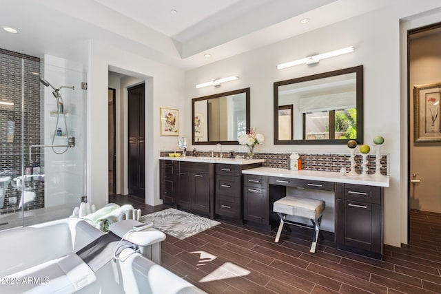 bathroom with vanity, separate shower and tub, and backsplash