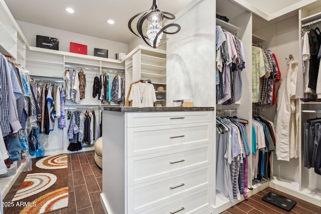 spacious closet with a chandelier