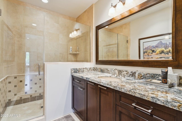 bathroom featuring vanity and a shower with door