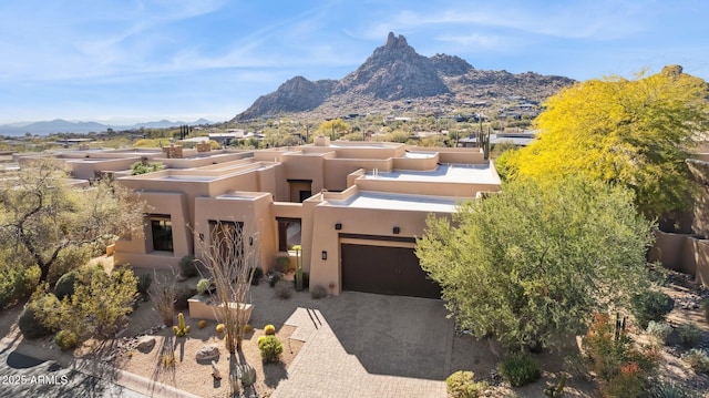 view of front of house with a mountain view and a garage