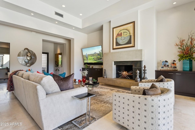 living room featuring a high end fireplace