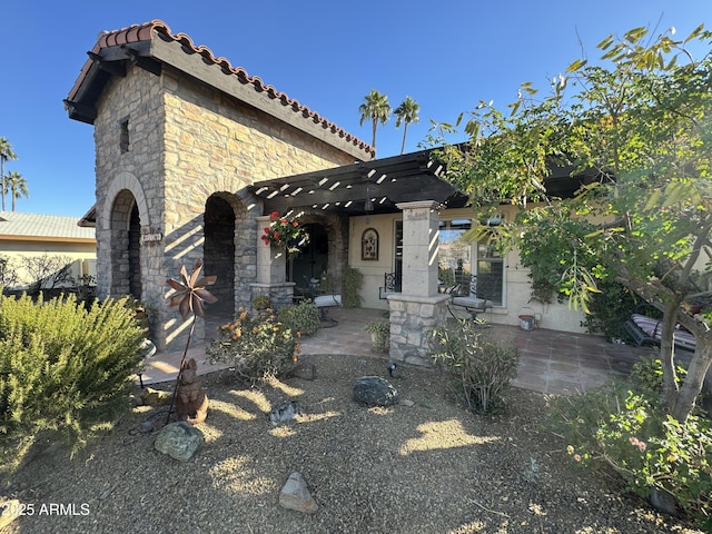 view of front of property with a pergola and a patio