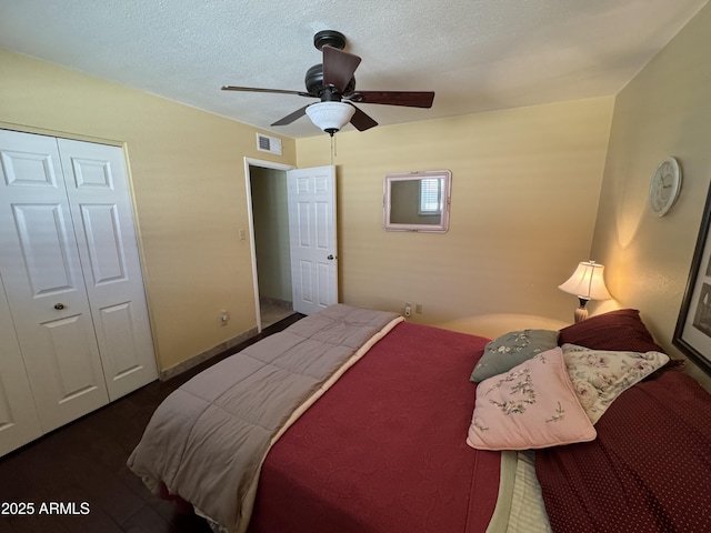 bedroom with a textured ceiling, ceiling fan, and a closet