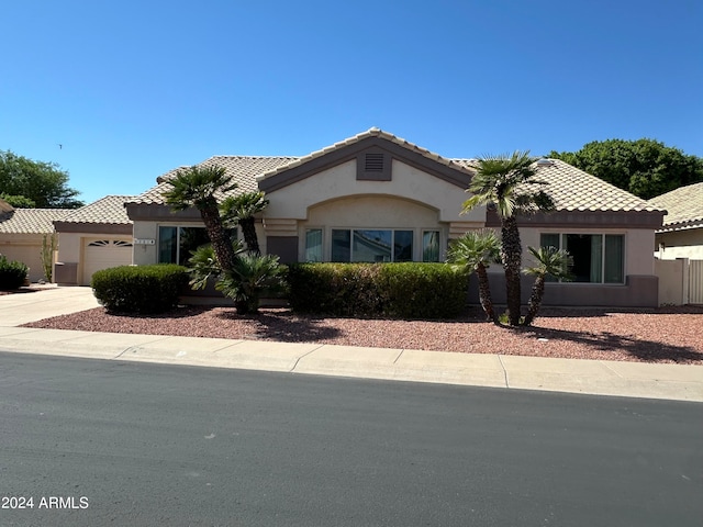 mediterranean / spanish-style home with a garage