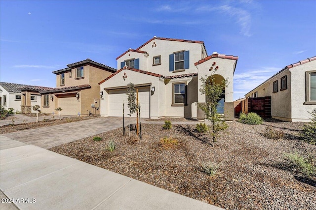 mediterranean / spanish-style home with a garage