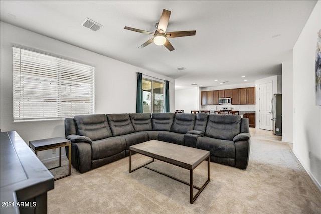 living room with light colored carpet and ceiling fan