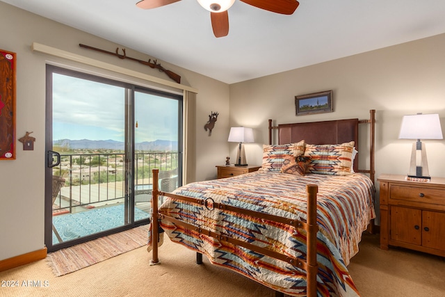 carpeted bedroom with ceiling fan, a mountain view, and access to exterior