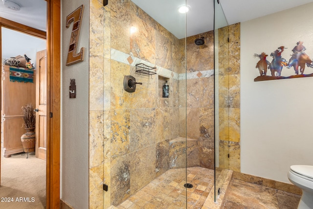 bathroom with toilet and an enclosed shower