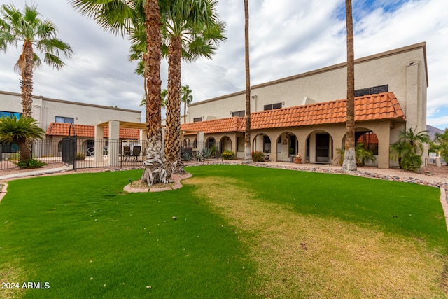 rear view of property with a lawn