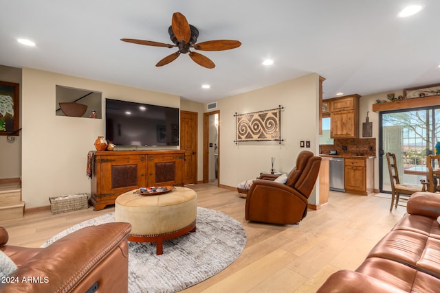 living room with ceiling fan and light hardwood / wood-style flooring