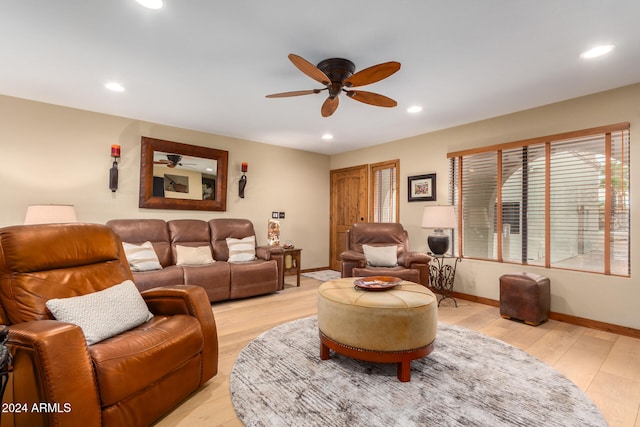 living room featuring ceiling fan and light hardwood / wood-style floors