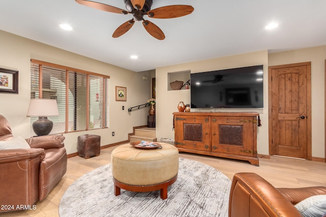 living room with ceiling fan and light hardwood / wood-style flooring