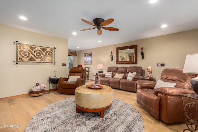 living room featuring light hardwood / wood-style flooring and ceiling fan