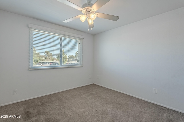 carpeted empty room with baseboards and ceiling fan