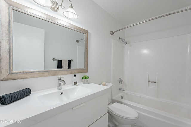 bathroom with toilet, vanity, and  shower combination