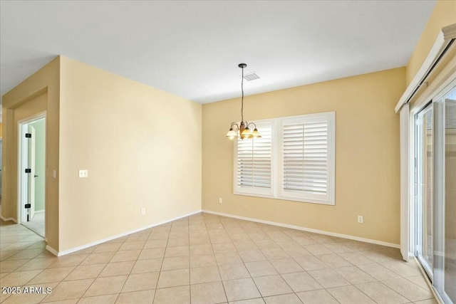 spare room featuring a wealth of natural light, a notable chandelier, baseboards, and light tile patterned floors