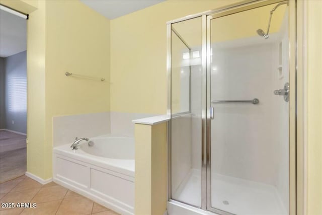 full bath with a garden tub, a stall shower, and tile patterned flooring