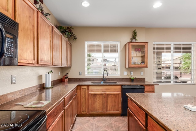 22022 W Moonlight Path, Buckeye, AZ 85326 - kitchen featuring black appliances, a sink, recessed lighting, dark stone counters, and glass insert cabinets