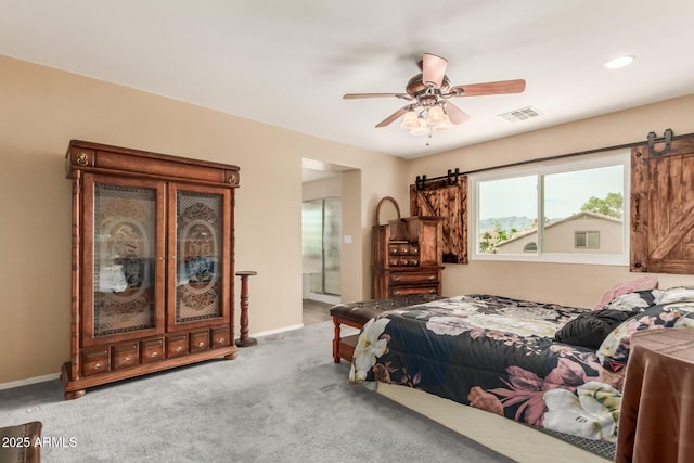 22022 W Moonlight Path, Buckeye, AZ 85326 - carpeted bedroom with a barn door, connected bathroom, baseboards, and ceiling fan