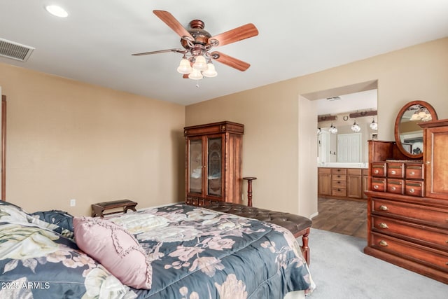 22022 W Moonlight Path, Buckeye, AZ 85326 - bedroom featuring ensuite bathroom, a ceiling fan, and carpet