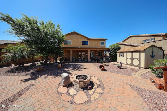 22022 W Moonlight Path, Buckeye, AZ 85326 - view of patio / terrace with an outdoor fire pit and french doors