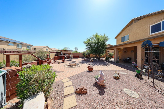 22022 W Moonlight Path, Buckeye, AZ 85326 - view of patio / terrace with an outdoor fire pit