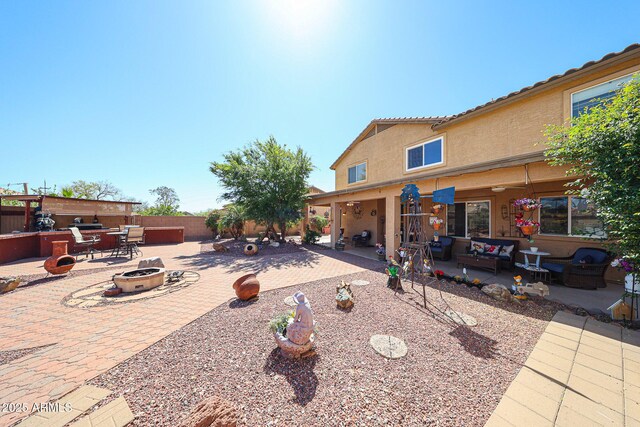22022 W Moonlight Path, Buckeye, AZ 85326 - fenced backyard with an outdoor living space with a fire pit and a patio area