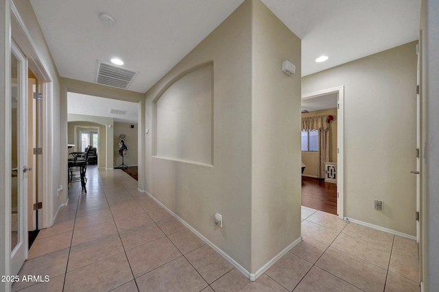 9926 W Gross Ave, Tolleson, AZ 85353 - hallway with light tile patterned floors, arched walkways, french doors, and recessed lighting