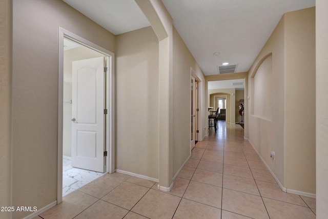 9926 W Gross Ave, Tolleson, AZ 85353 - hallway with arched walkways, light tile patterned floors, and recessed lighting