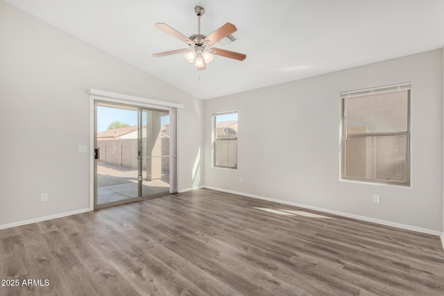 unfurnished room featuring vaulted ceiling, ceiling fan, baseboards, and wood finished floors
