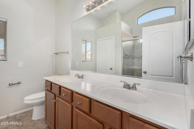 bathroom featuring a shower stall, a wealth of natural light, and a sink