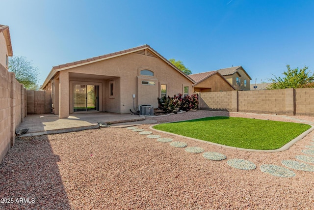back of property with central air condition unit, a tiled roof, a fenced backyard, a patio, and stucco siding